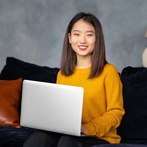 asian business woman working in laptop on sofa jap GM7YU66 copy 1